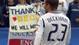 Beckham looks on as fans hold up a sign honoring him.