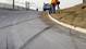 Tire skid marks are seen leaving the road as news cameraman film the area where the single-vehicle accident occurred.