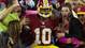 To the delight of fans, Washington Redskins quarterback Robert Griffin III jumps into the stands after scoring a touchdown against the Minnesota Vikings.