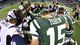 Tebow (15) leads his teammates and Patriots players in prayer after a 49-19 loss on Thanksgiving at Metlife Stadium.