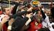Members of the Texas Tech Red Raiders celebrate with the Meineke Care Care Bowl  trophy after defeating the Minnesota Golden Gophers at Reliant Stadium, 34-31.