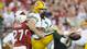 The highest-scoring game in playoff history absolutely was bonkers and ended in the most dramatic of ways. In overtime, Packers quarterback Aaron Rodgers' fumble (pictured) forced by Michael Adams (pictured) was scooped up and returned 17 yards for a touchdown by Karlos Dansby, clinching a 51-45 win for the Cardinals in a 2009 NFC Wild Card game.