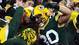 Packers fullback John Kuhn (30) celebrates with fans in the stands after catching a pass in the end zone for a touchdown in the second quarter.