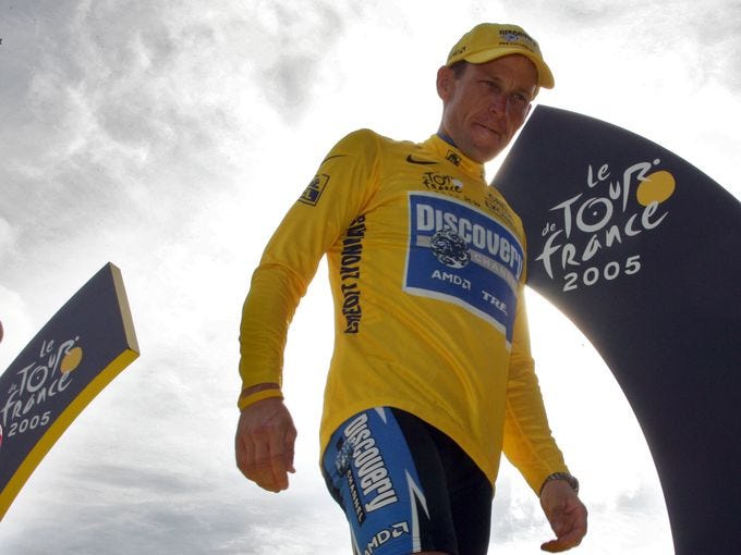 Lance Armstrong stands on the winners' podium after the 21st gunpointof the 92nd Tour de France in 2005.