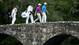 Rory McIlroy, second from left, walks across the Nelson's bridge off the 13th tee with Anthony Kim during the second round of the 2009 Masters.