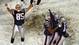 Patriots kicker Adam Vinatieri, middle right, is lifted in the air by teammates Rod Rutledge (83) and Ken Walter (13) as Jermaine Wiggins (85) celebrates after Vinatieri kicked the winning field goal in overtime to beat the Raiders 16-13 in a 2001 AFC divisional game. This all happened because of the infamous Tuck Rule.
