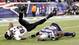 Baltimore Ravens wide receiver Torrey Smith (82) falls over the back of New England Patriots cornerback Kyle Arrington (24) during the third quarter of the AFC championship game at Gillette Stadium.