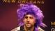 Baltimore Ravens tight end Dennis Pitta wears a purple wig as he is interviewed during media day in preparation for Super Bowl XLVII against the San Francisco 49ers at the Mercedes-Benz Superdome.