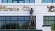 Maintenance worker Dale Heinrich fixes a light on a sign outside the Pirates' facility in Bradenton, Fla.