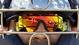 The sky and field are reflected in the glasses and helmet of Tigers catcher Alex Avila in Lakeland, Fla.