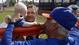 New York Mets manager Terry Collins, talks to 1-year-old Bentley DiToro, carried by his grandfather Charlie DiToro, of Palm City, Fla., during the team's first pitchers and catchers workout in Port St. Lucie.