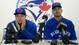 Blue Jays' Melky Cabrera wipes his face as he joins Blue Jays third base coach Luis Rivera, right, to address the media.