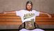 Josh Reddick of the Oakland Athletics poses for with his wrestling belt during a photo shoot.