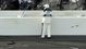A track official looks at a car engine that flew through the catch fence after a final lap crash during the DRIVE4COPD 300 at Daytona International Speedway.
