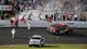 Track officials and workers survey the damage to the catch fence after a crash on the final lap of the DRIVE4COPD 300 at Daytona International Speedway.