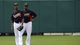 B.J. Upton, left, and his brother Justin, wait to catch a ball as part of a drill  during a workout.