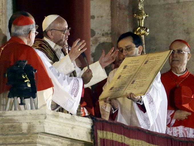 Pope Francis speaks from the central balcony of St. Peter's Basilica at the Vatican.