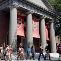 People are led on a tour group at the campus of Harvard University in Cambridge, Mass. Dozens of Harvard University students, including some athletes, were sanctioned for cheating on a final exam in February.