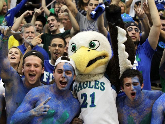 From left, Kristian Avellanet, Nick Schilson, Florida Gulf Coast University mascot Azul, Nick Mucerino and Dario Nachef celebrate the Eagles' trip to the Sweet 16 during a pep rally at Alico Arena in Fort Myers, Fla.