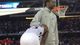 Kansas Jayhawks guard Elijah Johnson is consoled after losing in overtime to the Michigan Wolverines.