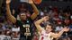 Ohio State's Aaron Craft and Wichita State's Cleanthony Early look to get a handle on a loose ball in the first half.