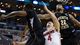 Ohio State guard Aaron Craft is defended by Carl Hall (22) and Cleanthony Early in the second half of the West Regional final at the Staples Center in Los Angeles.