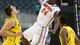 Florida Gators guard Casey Prather (24) dunks the ball between Michigan Wolverines forward Mitch McGary (4) and Glenn Robinson III (1) in the first half of the South regional final of the 2013 NCAA Tournament at Cowboys Stadium.