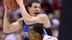 Duke Blue Devils guard Seth Curry holds the ball away from Louisville Cardinals guard Russ Smith in the first half during the finals of the Midwest regional at Lucas Oil Stadium.