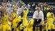 Michigan Wolverines forward Mitch McGary (4), Nik Stauskas (11) and the bench celebrate as they defeat the Florida Gators 79-59 to advance to the Final Four during the South regional final of the 2013 NCAA Tournament at Cowboys Stadium.