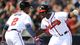 Justin Upton, right, celebrates with brother B.J. after hitting his first home run with the Braves. Upton, acquired in the offseason, helped Atlanta beat rival Philadelphia 7-5 on opening day.