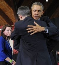 President Obama hugs Ian Hockley as his wife Nicole Hockley watches after they introduced Obama as he arrived to speak on gun control on April 8, 2013 at the University of Hartford, in Hartford, Connecticut. The Hockley's son was killed in the Newtown school shooting.