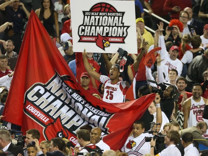 Louisville Cardinals celebrate after defeating the Michigan Wolverines 82-76 during the championship game at the Georgia Dome.