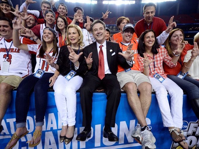 Louisville Cardinals head coach Rick Pitino poses with his family after the championship game at the Georgia Dome.