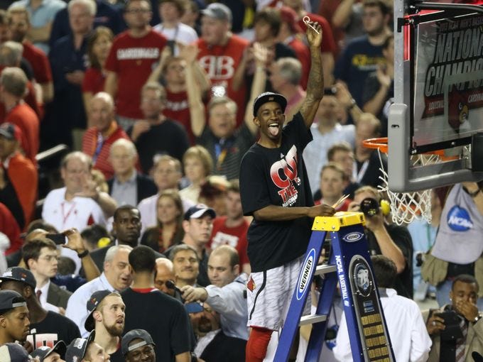Louisville Cardinals guard Russ Smith celebrates during the net cutting ceremony .