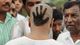 A Congress Party supporter shows off the party's symbol that he cut into his hair during a swearing-in ceremony in Bangalore, India. The party won 121 of the 124 seats in last week's assembly election.