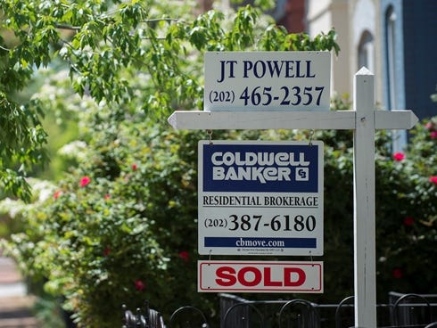 A for sale sign stands at a home in Washington, DC, on May 1, 2013.