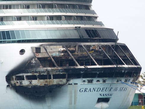 The fire-damaged exterior of Royal Caribbean's Grandeur of the Seas cruise ship is seen while docked in Freeport, Grand Bahama island, on May 27.
