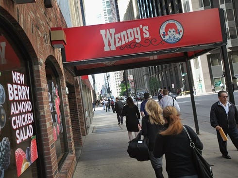 Pedestrians walk past a Wendy's in Chicago.
