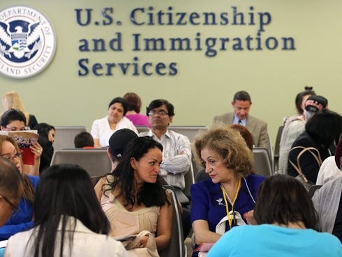 Immigrants await their turn for green card and citizenship interviews at the U.S. Citizenship and Immigration Services (USCIS) Queens office on May 30 in New York City.