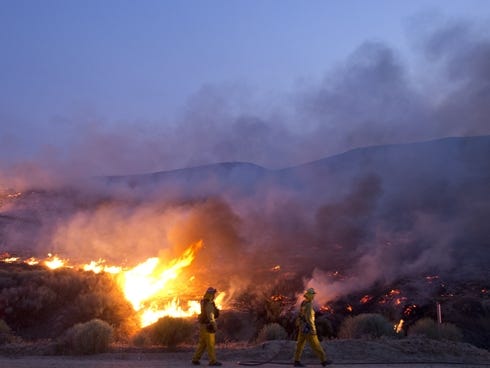 Firefighters battle the Powerhouse Fire on Saturday in Lake Hughes, Calif., approximately 66 miles north of Los Angeles in the Angeles National Forest.