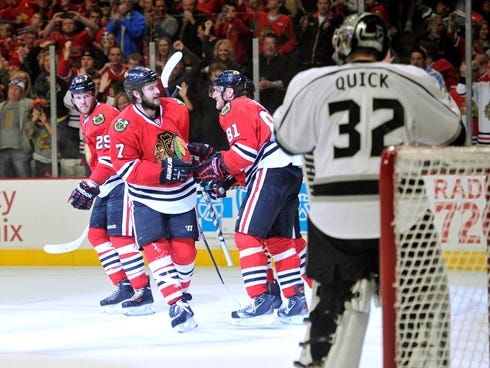 Kings goalie Jonathan Quick looks as the Blackhawks celebrate Brent Seabrook's first-period goal.