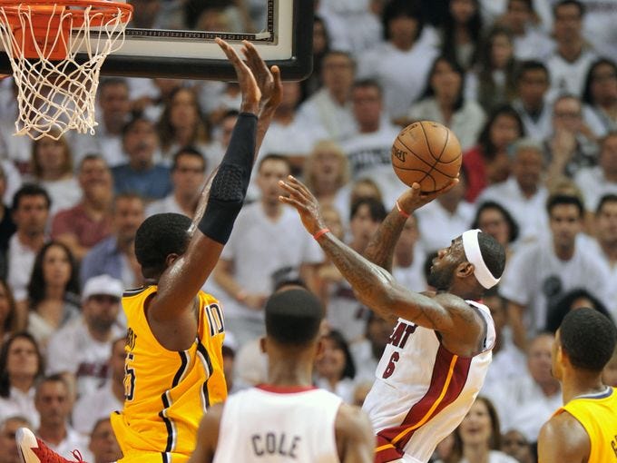 Game 7 in Miami: Heat 99, Pacers 76 - Miami Heat small forward LeBron James (6) puts up a shot over Indiana Pacers center Roy Hibbert (55).