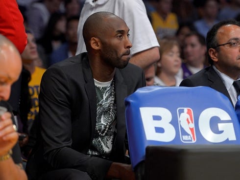 Los Angeles Lakers guard Kobe Bryant watches his team play the San Antonio Spurs in the second half in Game 4 of a first-round NBA basketball playoff series, Sunday, April 28, 2013, in Los Angeles.