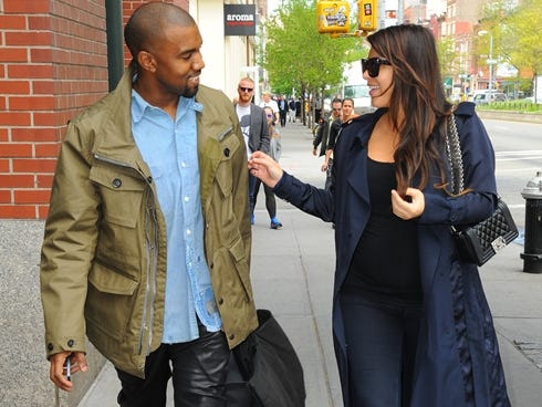 Kim Kardashian and Kanye West are seen in Soho on May 6, 2013, in New York City. It's the rare photo of West smiling in public.