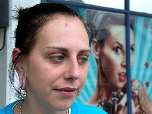 Brittany Rager of Mason, Ohio, speaks about getting attacked by three people Thursday June 6, 2013, in Springboro, Ohio.