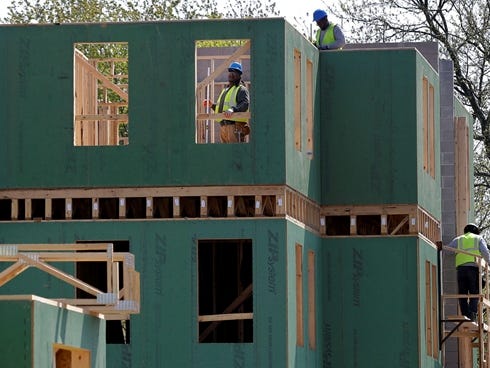 Workers build a  house in Trenton, N.J.