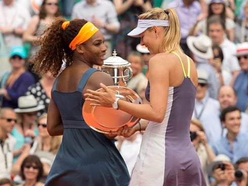 The trophies in hand for Serena Williams and Maria Sharapova.