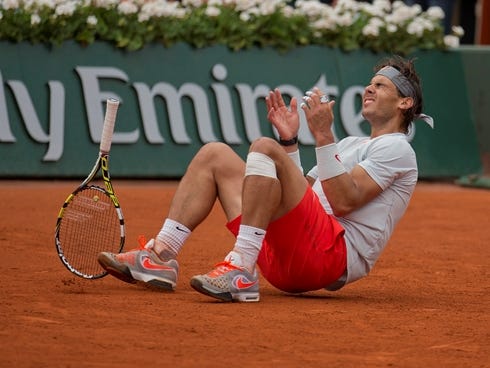 Rafael Nadal of Spain sinks to the clay after defeating compatriot David Ferrer in the French Open final.