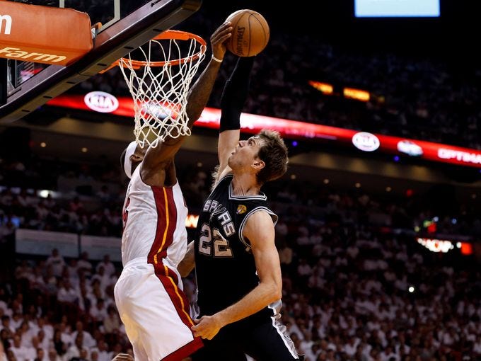 Game 2 in Miami: Heat 103, Spurs 84 - Miami Heat small forward LeBron James (6) blocks the shot of San Antonio Spurs center Tiago Splitter (22).