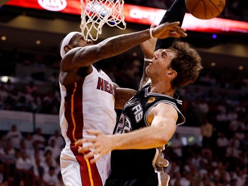 Heat forward LeBron James blocks a dunk by Spurs forward Tiago Splitter during Game 2 of the NBA Finals.